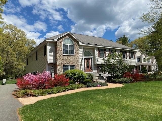 bi-level home with a front lawn