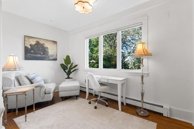 home office featuring a baseboard radiator and wood finished floors