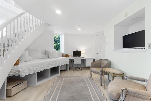 living area with light wood-type flooring, stairway, and recessed lighting