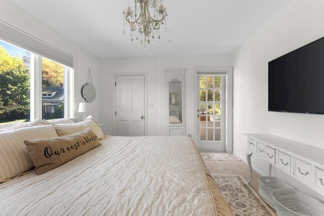 bedroom featuring multiple windows and an inviting chandelier