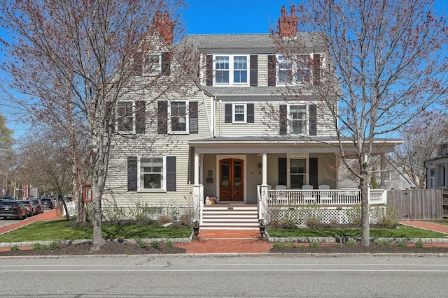 view of front of home featuring a porch and a chimney
