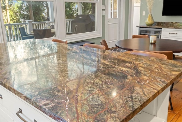 dining space featuring wine cooler and a healthy amount of sunlight