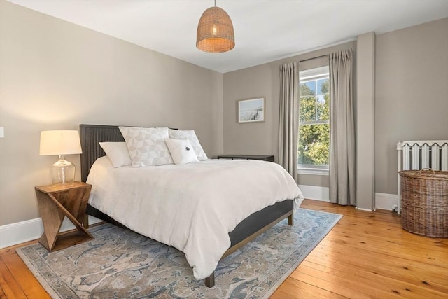 bedroom featuring light wood-style flooring and baseboards