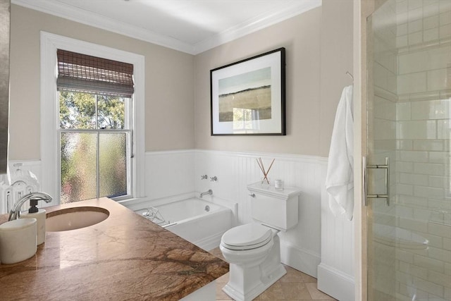bathroom featuring a wainscoted wall, toilet, a garden tub, a stall shower, and crown molding