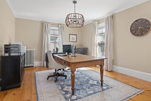 office space with radiator heating unit, baseboards, light wood-type flooring, and ornamental molding