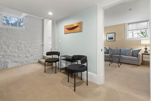 sitting room with recessed lighting, light colored carpet, and baseboards