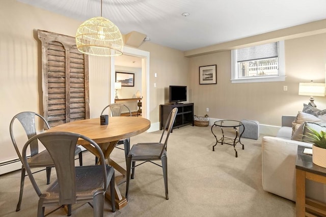 carpeted dining area with baseboards