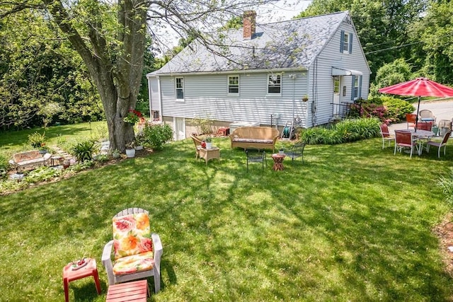 39 Crest Ave, Lunenburg, MA 01462 - back of house with a chimney, a yard, and roof with shingles