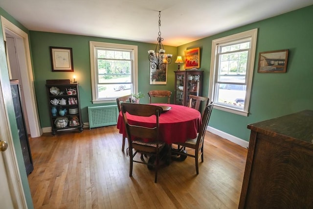 39 Crest Ave, Lunenburg, MA 01462 - dining room with hardwood / wood-style floors, radiator heating unit, a chandelier, and plenty of natural light