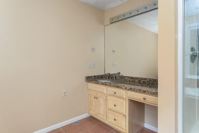 bathroom with tile patterned floors, baseboards, and vanity