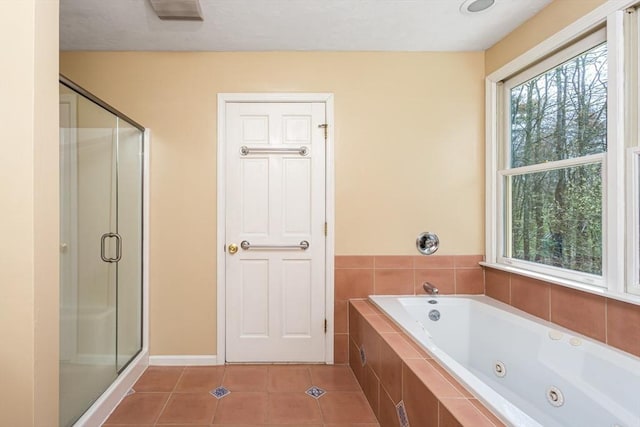 bathroom featuring plenty of natural light, tile patterned flooring, and a shower stall