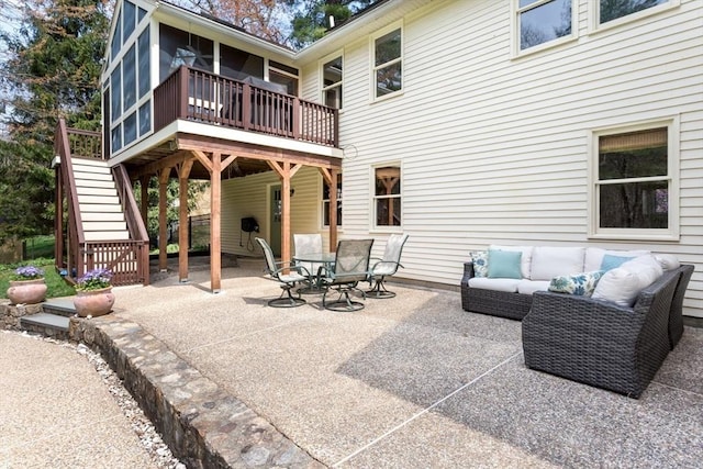 view of patio / terrace with an outdoor living space, a wooden deck, and stairs