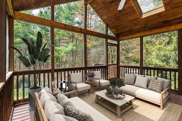 sunroom featuring an outdoor living space, a ceiling fan, and a skylight