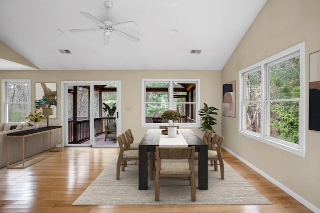dining area featuring plenty of natural light, vaulted ceiling, and visible vents