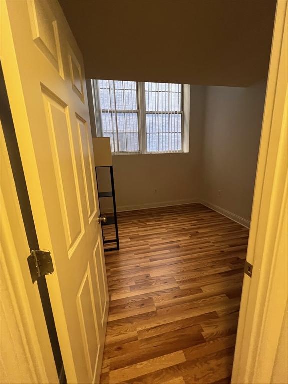 unfurnished room featuring baseboards and wood finished floors