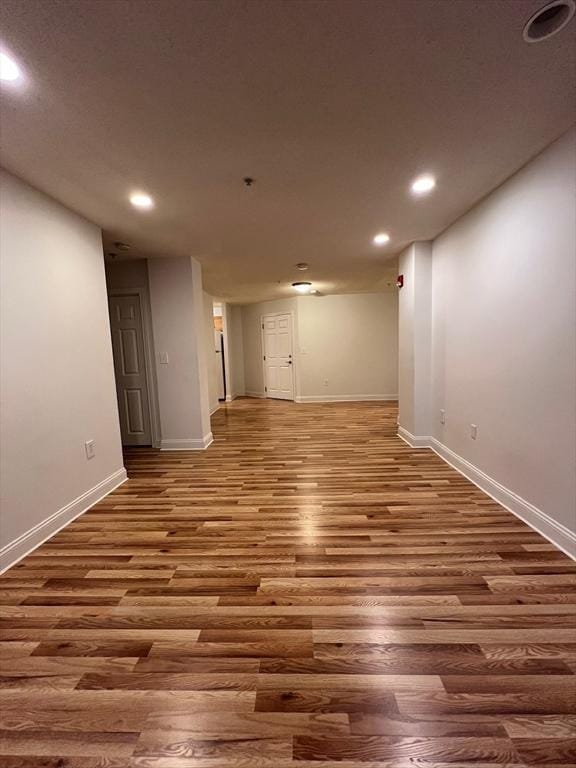 below grade area with recessed lighting, baseboards, and wood finished floors