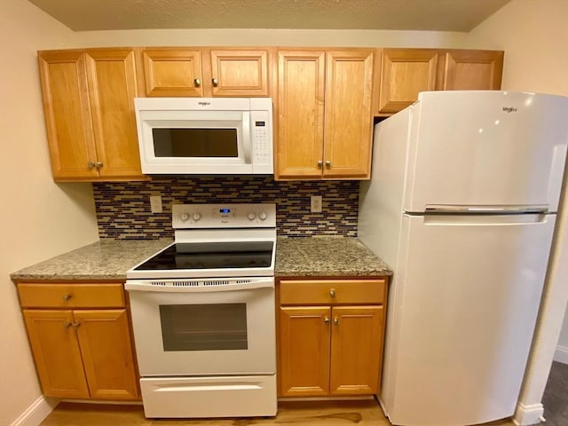 kitchen featuring white appliances and backsplash