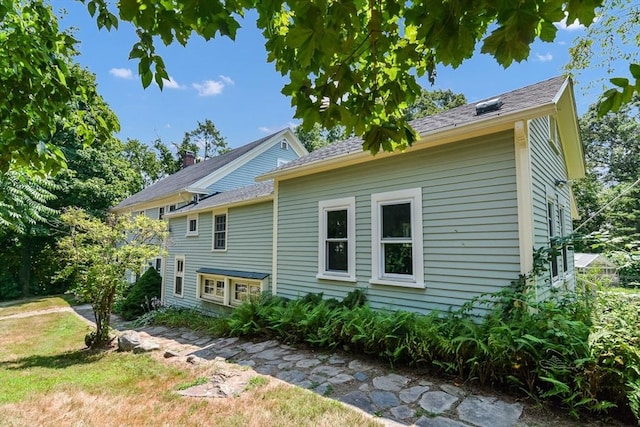 rear view of property with a lawn