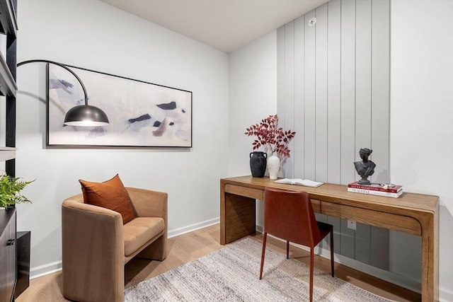 home office featuring baseboards and wood finished floors