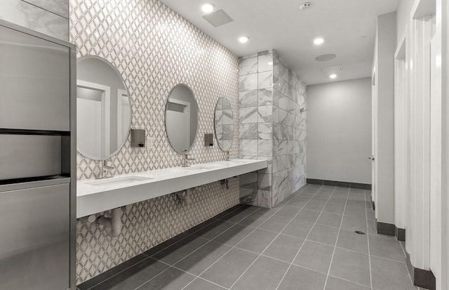 bathroom featuring a sink, tile patterned floors, recessed lighting, and double vanity
