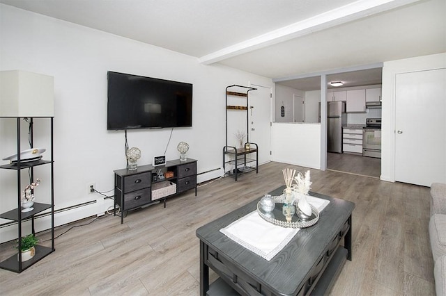 living room featuring a baseboard heating unit, beam ceiling, and light wood-style floors