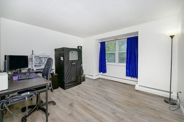 office area featuring light wood-style floors and a baseboard heating unit