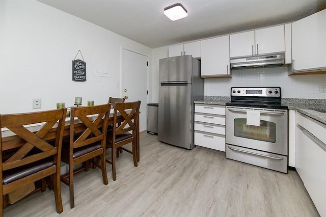 kitchen with light wood-style flooring, under cabinet range hood, decorative backsplash, stainless steel appliances, and white cabinets