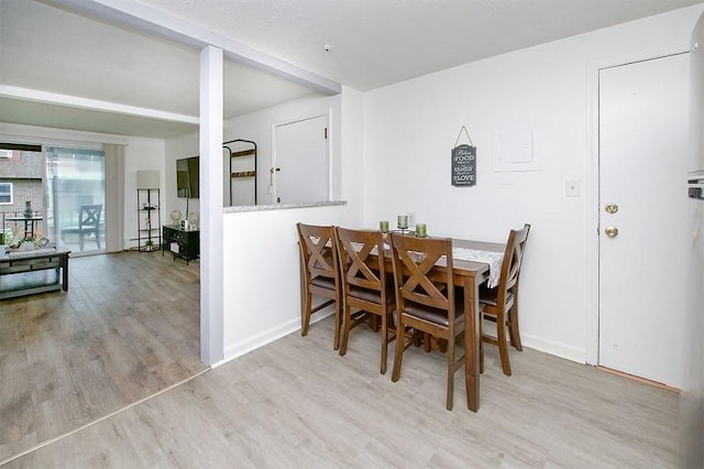 dining room with wood finished floors and baseboards