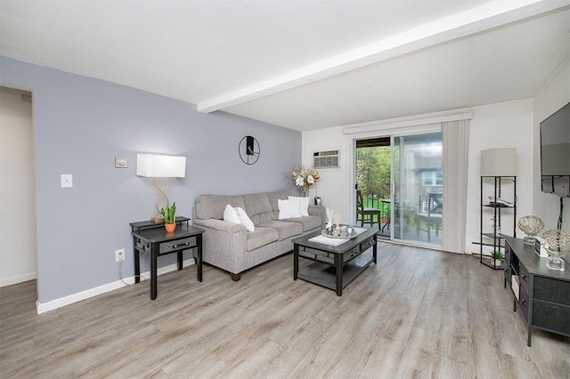 living area with a wall mounted air conditioner, beam ceiling, baseboards, and light wood-type flooring