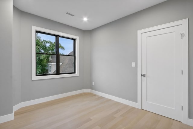 spare room featuring light hardwood / wood-style flooring