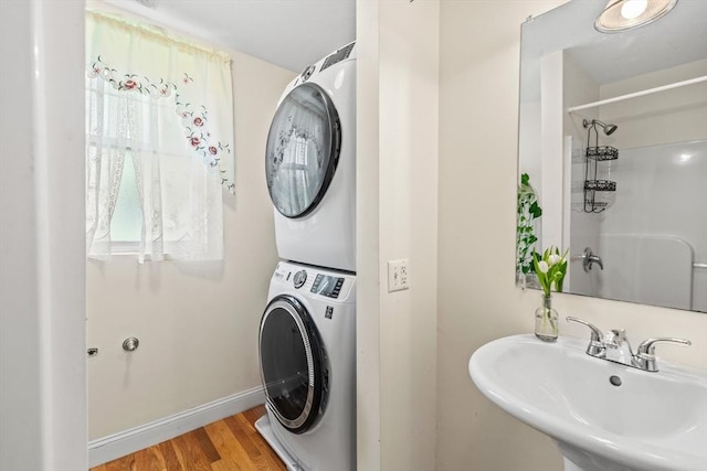 4-6 Marcella St Unit 2, Boston, MA 02119 - washroom with stacked washer / dryer, wood finished floors, and baseboards