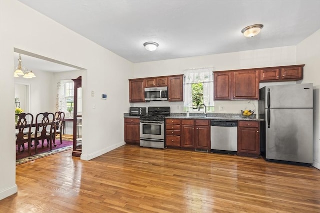 4-6 Marcella St Unit 2, Boston, MA 02119 - kitchen with stainless steel appliances, light wood-type flooring, a sink, and baseboards