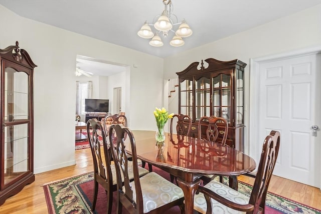 4-6 Marcella St Unit 2, Boston, MA 02119 - dining area featuring a chandelier, light wood-style floors, and baseboards