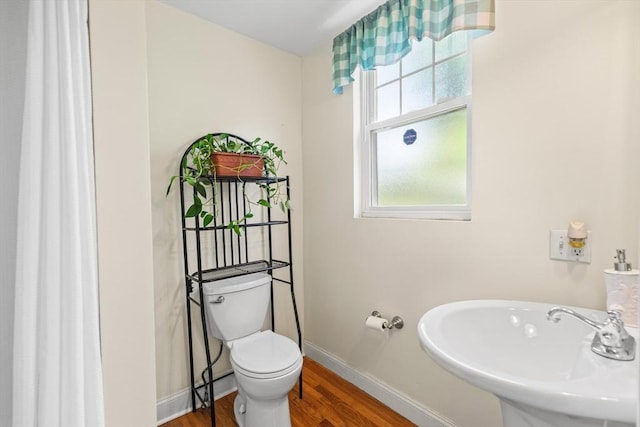 4-6 Marcella St Unit 2, Boston, MA 02119 - bathroom featuring a sink, wood finished floors, toilet, and baseboards