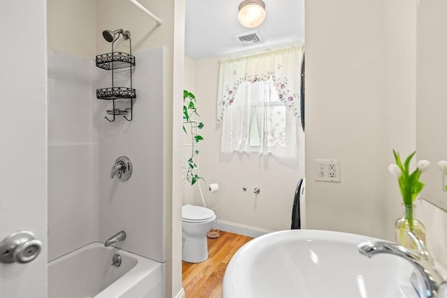 4-6 Marcella St Unit 2, Boston, MA 02119 - bathroom with wood finished floors, toilet, washtub / shower combination, and baseboards