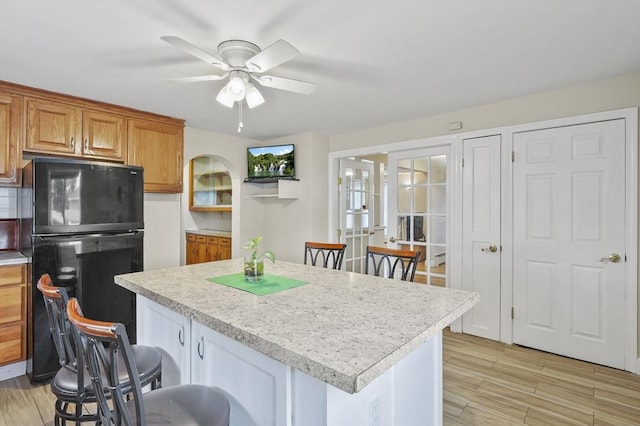 0 Steeple View Way, Leominster, MA 01453 - kitchen featuring freestanding refrigerator, a breakfast bar, light countertops, and light wood-style floors