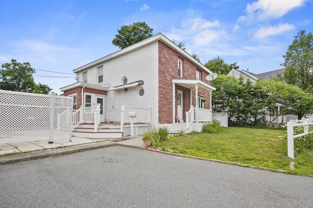 0 Steeple View Way, Leominster, MA 01453 - view of front of home with a front yard, stucco siding, brick siding, and a deck