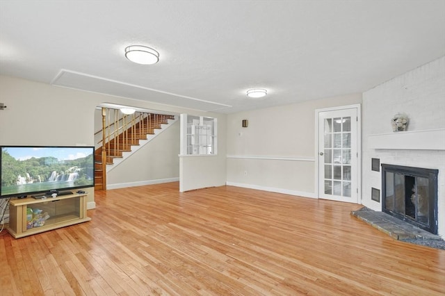 0 Steeple View Way, Leominster, MA 01453 - unfurnished living room with hardwood / wood-style floors, stairs, and a fireplace