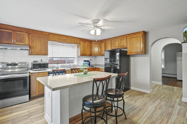 0 Steeple View Way, Leominster, MA 01453 - kitchen featuring stainless steel appliances, under cabinet range hood, light countertops, ceiling fan, and light wood-style floors