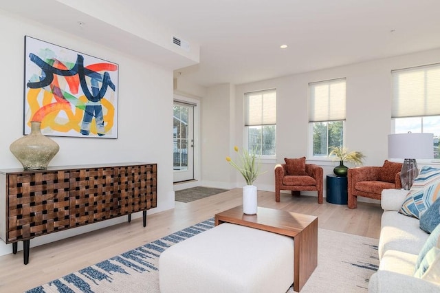 living room featuring visible vents, wood finished floors, and recessed lighting