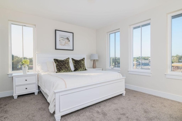 bedroom featuring carpet floors and baseboards