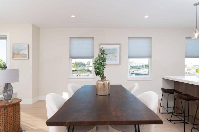 dining space with recessed lighting, light wood-style flooring, and baseboards