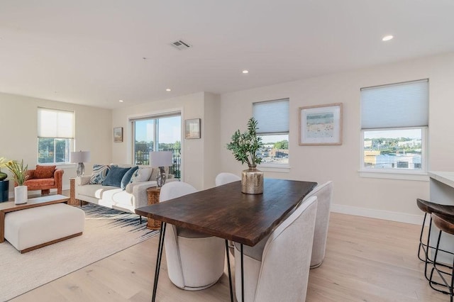 dining area with recessed lighting, visible vents, and light wood-style flooring