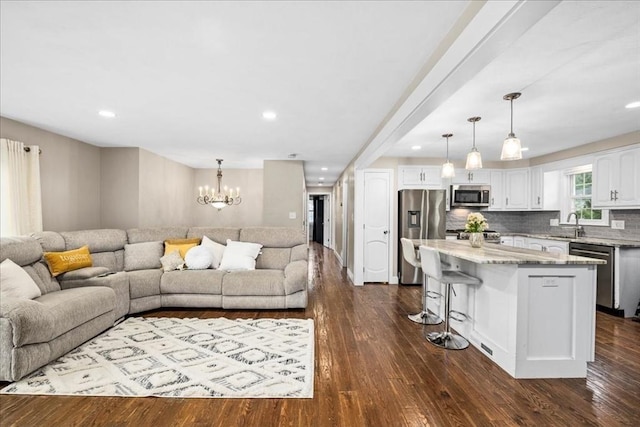 40 Richard Ave, Shrewsbury, MA 01545 - living room with a chandelier, recessed lighting, and dark wood-style flooring