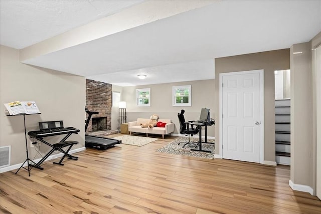 40 Richard Ave, Shrewsbury, MA 01545 - living area with stairs, light wood-style flooring, a fireplace, and baseboards