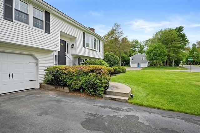 40 Richard Ave, Shrewsbury, MA 01545 - view of home's exterior featuring a lawn and a chimney