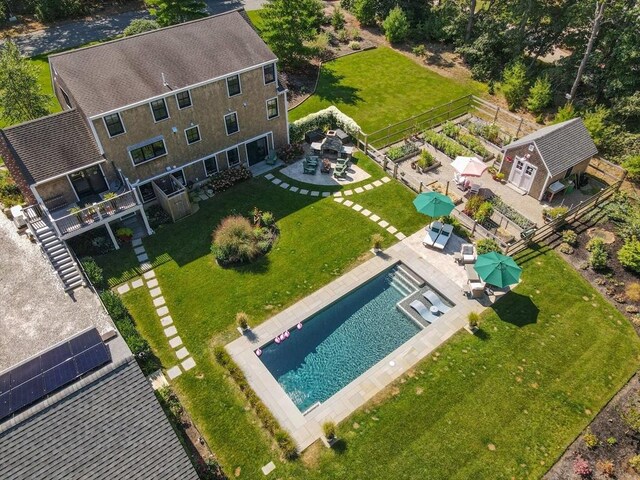 view of front of home featuring a garage, a front lawn, and an outbuilding