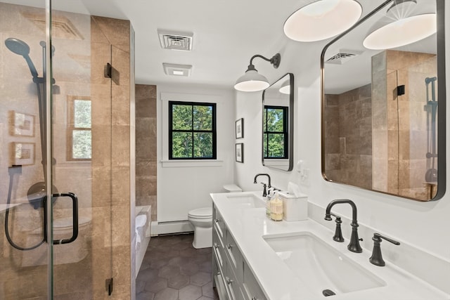 bathroom with vanity, toilet, an enclosed shower, and a baseboard radiator