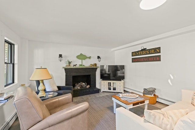 living room with baseboard heating, hardwood / wood-style flooring, and a fireplace