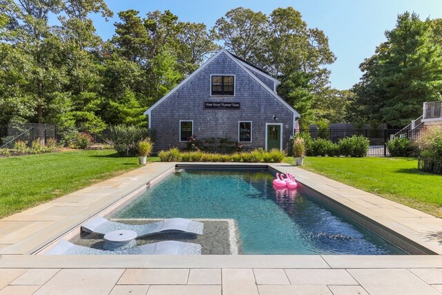 view of swimming pool featuring a lawn